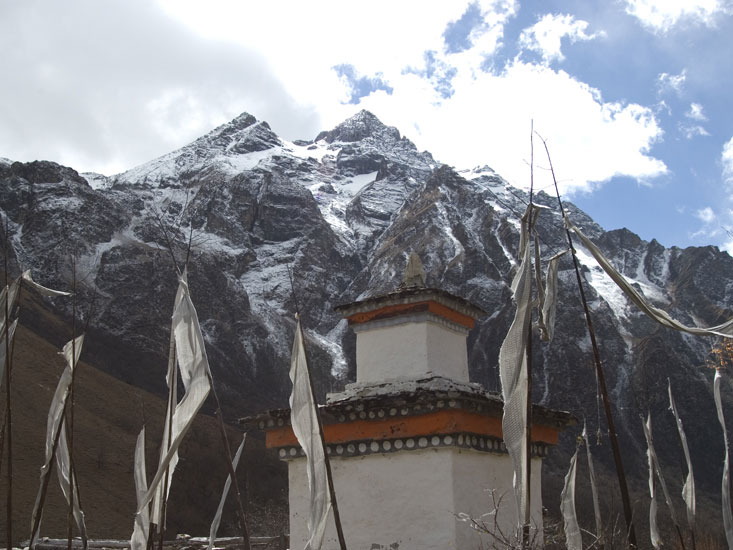 A view of a chorten, prayer flags, and a mountain in Bhutan