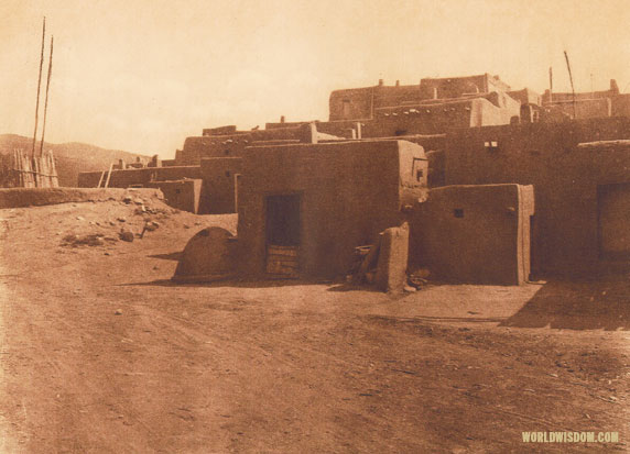 "A corner of Taos and a kiva entrance" - Taos, by Edward S. Curtis from The North American Indian Volume 16
